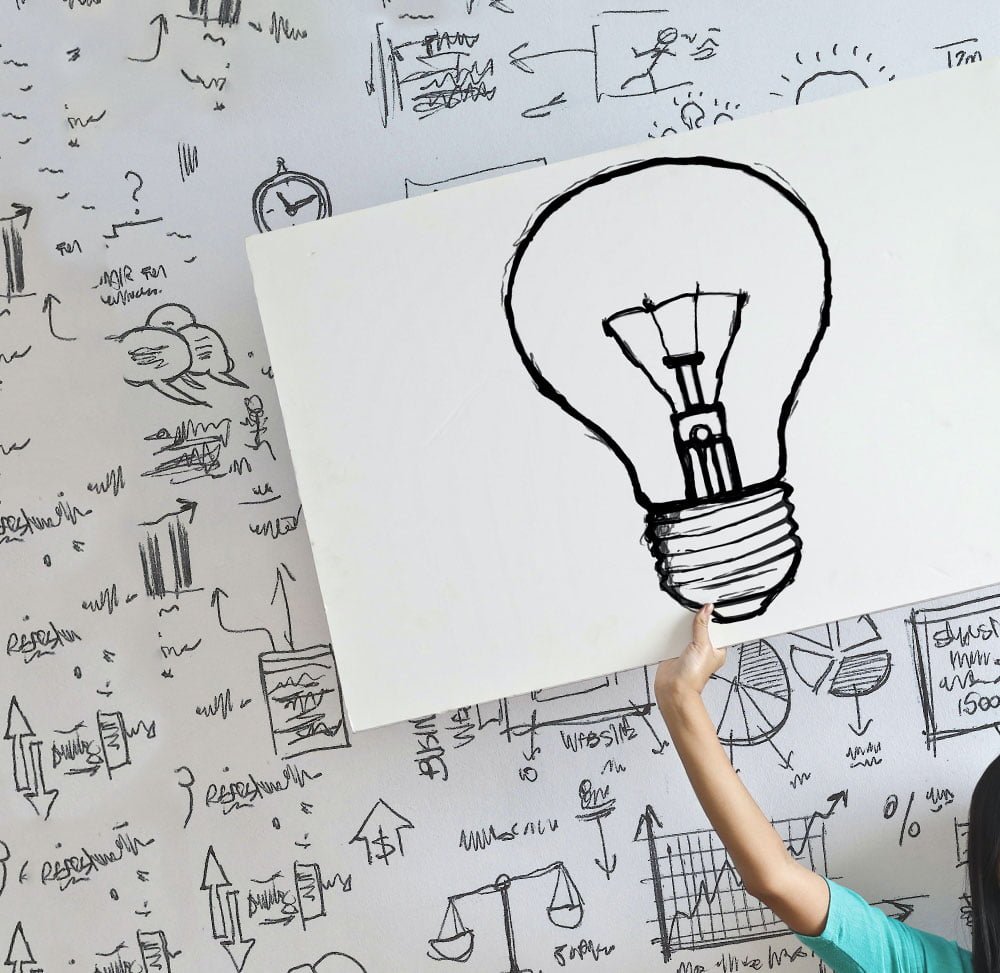 RiBrand Marketing Agency Dubai Woman Personnel Holding Image of Hand Drawn Lightbulb Creative Background