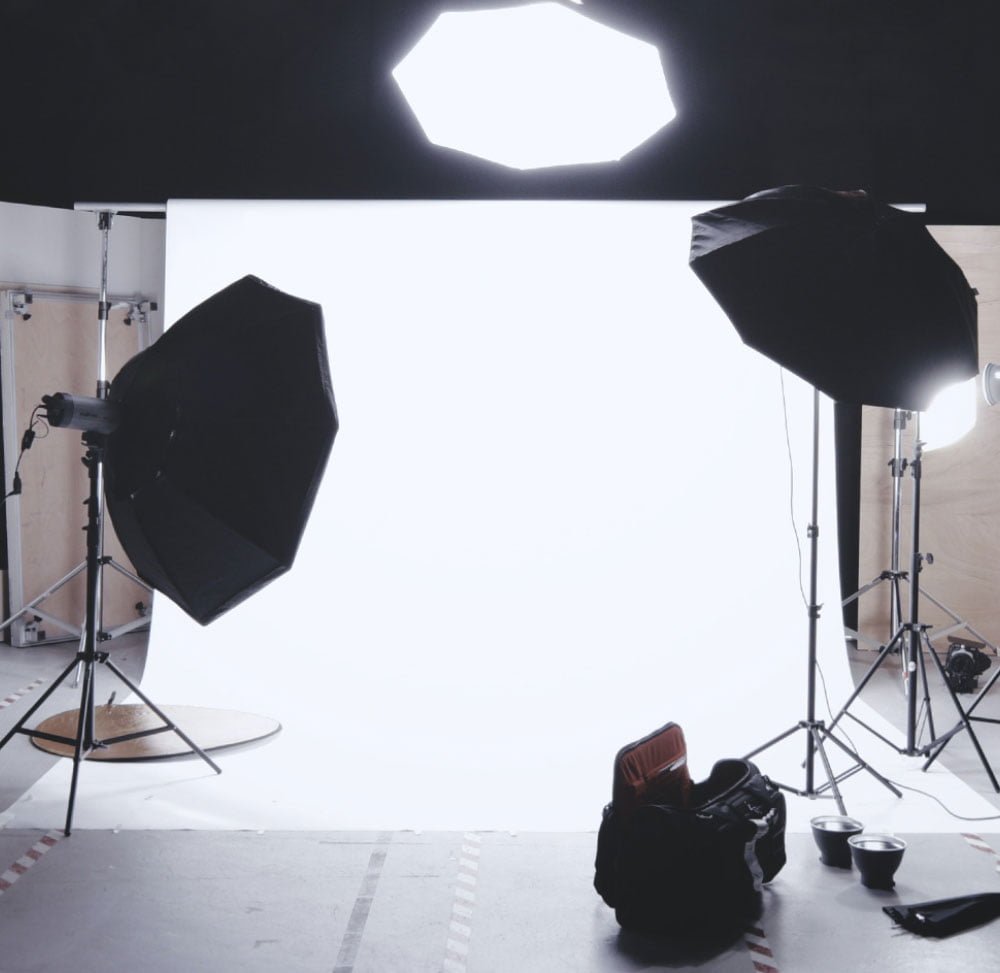 Photography setup in a studio with lightboxes and a backdrop