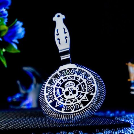 Skull Shaped Hawthorne Strainer around a dark blue background