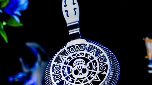 Skull Shaped Hawthorne Strainer around a dark blue background