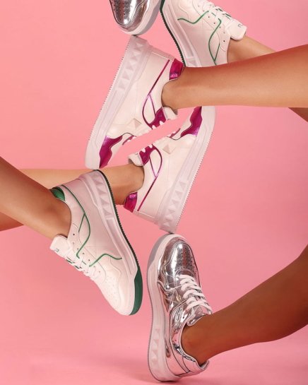 Five different fashion style shoes displayed on five different legs of woman models