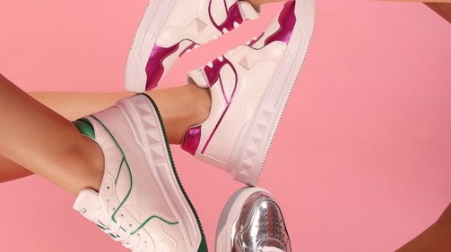 Five different fashion style shoes displayed on five different legs of woman models