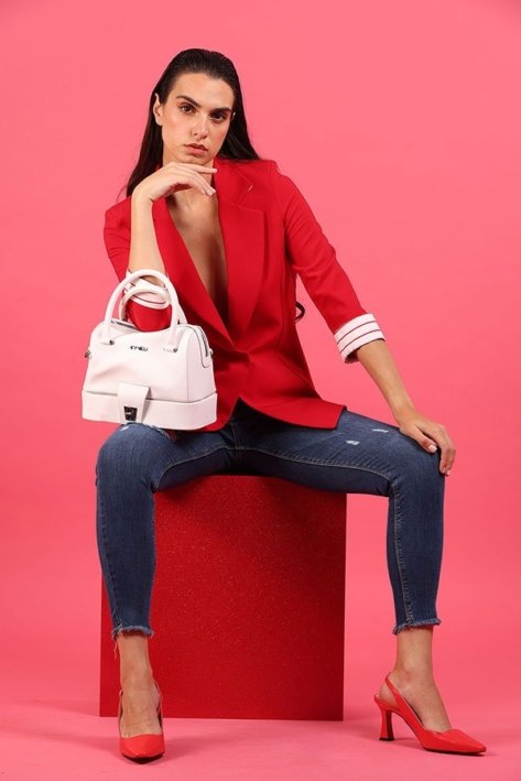 Young Woman Model wearing a red shirt and blue jeans and carrying a pink bag