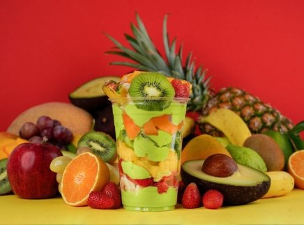 Avocado mixed cocktail around fruits background