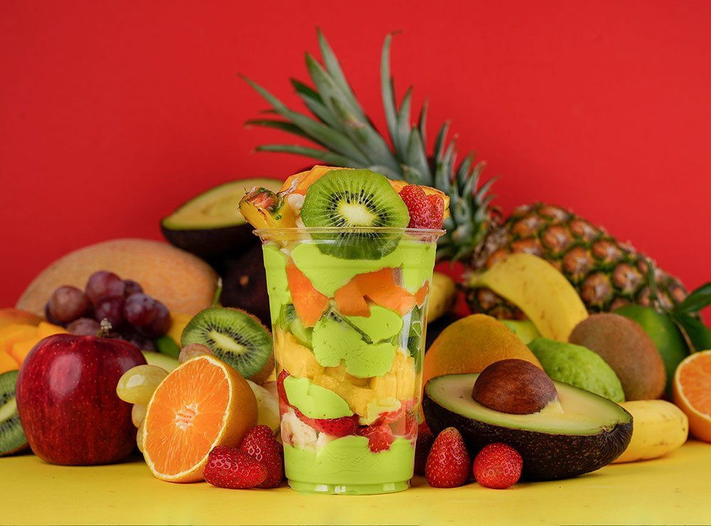 Avocado mixed cocktail around fruits background