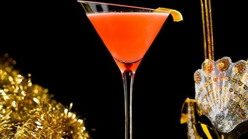 Orange Gin and Sin Cocktail around Confetti Background