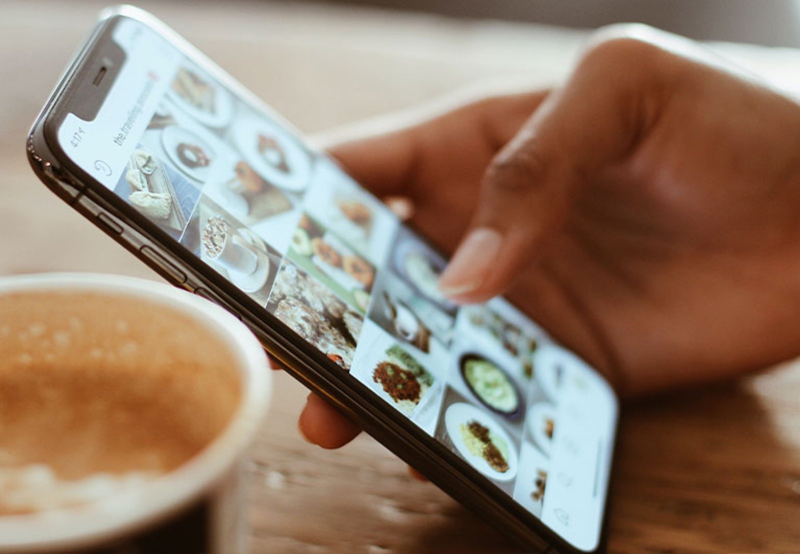 Hand Holding Phone Viewing Images In Gallery