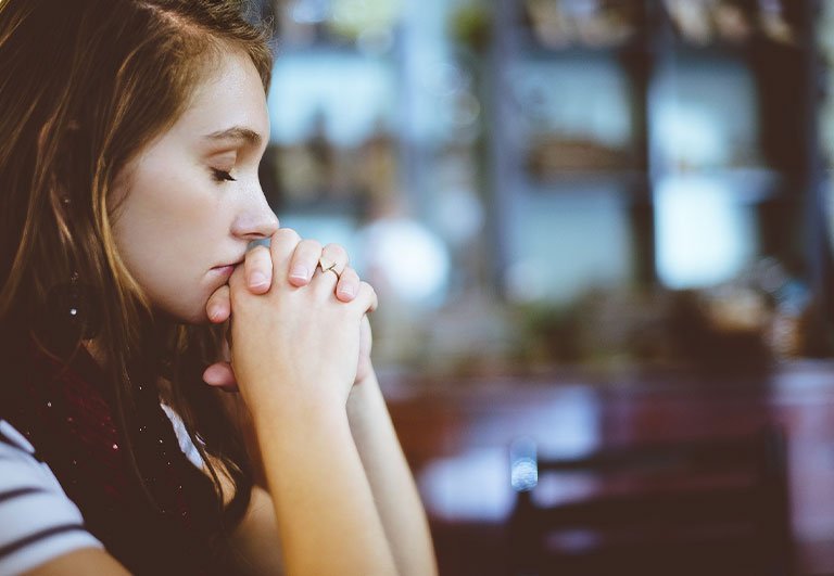 Woman With Closed Eyes and Crossed Hands